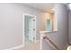 Upstairs hallway with carpet, neutral walls, and doors to bedrooms and a bathroom at 204 Cardinal Ct, Oxford, NC 27565