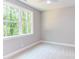 Spacious bedroom with carpet, neutral walls, and a large window at 204 Cardinal Ct, Oxford, NC 27565