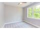 Well-lit bedroom featuring a large window and grey carpet at 206 Cardinal Ct, Oxford, NC 27565