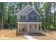 Two-story house with gray and blue siding, front porch and landscaping at 206 Cardinal Ct, Oxford, NC 27565