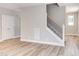 Modern staircase with metal railing and hardwood floors at 206 Cardinal Ct, Oxford, NC 27565