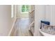 Hardwood floor hallway with modern staircase and built in bench at 206 Cardinal Ct, Oxford, NC 27565