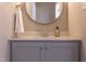 Modern bathroom vanity with gray cabinets and a round mirror at 206 Cardinal Ct, Oxford, NC 27565