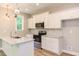Modern kitchen with white cabinets, granite countertops, and stainless steel appliances at 206 Cardinal Ct, Oxford, NC 27565