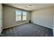 Bright bedroom featuring two windows and grey carpet at 295 Earnest Way, Kenly, NC 27542