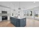 Modern kitchen with island, white cabinets, and blue accents at 5049 Lundy Dr # 101, Raleigh, NC 27606