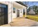 Front entrance of a modern farmhouse with black door and white siding at 329 Roxboro St, Haw River, NC 27258