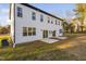 Rear view of a white house showcasing two sliding glass doors and a patio at 329 Roxboro St, Haw River, NC 27258