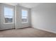 Spacious bedroom with two large windows and carpeted floor at 1019 Westerland Way # 51, Durham, NC 27703