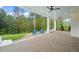 Covered patio with fire pit and ample seating overlooking the backyard at 1621 Legacy Ridge Ln, Wake Forest, NC 27587