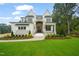 Luxury two-story home, white brick, stone accents, and lush landscaping at 1621 Legacy Ridge Ln, Wake Forest, NC 27587