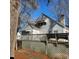 Backyard view showcasing a wooden deck with lattice and seating at 1852 Nc 62 Hwy N, Burlington, NC 27217