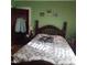 Bedroom with wood bedframe and green walls at 1852 Nc 62 Hwy N, Burlington, NC 27217