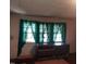Bright bedroom with green curtains and wooden furniture at 1852 Nc 62 Hwy N, Burlington, NC 27217