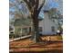White home nestled among trees, featuring a sunroom and wooden ramp at 1852 Nc 62 Hwy N, Burlington, NC 27217