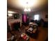 Cozy living room with a fireplace, piano, and comfortable seating at 1852 Nc 62 Hwy N, Burlington, NC 27217