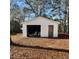 White storage building with open garage door and furniture inside at 1852 Nc 62 Hwy N, Burlington, NC 27217