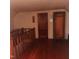 Upstairs room featuring hardwood floors and a wooden railing at 1852 Nc 62 Hwy N, Burlington, NC 27217