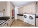 Laundry room with built-in cabinets, granite counters, and a washer/dryer at 32529 Archdale, Chapel Hill, NC 27517