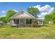 White house with a green lawn, showcasing classic architecture at 317 Quintas Ave, Burlington, NC 27215