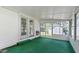 Bright sunroom with access to backyard and green carpet at 317 Quintas Ave, Burlington, NC 27215