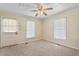 Bright living room featuring two windows, neutral carpeting, and ceiling fan at 317 Quintas Ave, Burlington, NC 27215