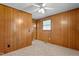 Bedroom featuring wood paneled walls and a ceiling fan at 317 Quintas Ave, Burlington, NC 27215