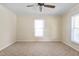 Simple bedroom with ceiling fan and neutral colored carpet at 317 Quintas Ave, Burlington, NC 27215