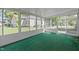 Sunroom features green carpet and plenty of natural light at 317 Quintas Ave, Burlington, NC 27215