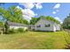 Rear view of a charming house with a detached shed and a spacious lawn at 317 Quintas Ave, Burlington, NC 27215