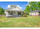 White house with a green lawn, showcasing classic architecture at 317 Quintas Ave, Burlington, NC 27215