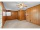 Bright living room with wood paneled walls and ceiling fan at 317 Quintas Ave, Burlington, NC 27215