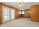 Spacious living room featuring wood paneled walls and a ceiling fan at 317 Quintas Ave, Burlington, NC 27215