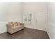 Bright living room with hardwood floors, a sofa, and a view of the front door at 1121 Talisker Way, Burlington, NC 27215
