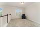 Spacious landing with neutral carpeting and window seat at 1121 Talisker Way, Burlington, NC 27215