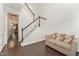 Bright entryway with staircase, hardwood floors, and a small sofa at 1121 Talisker Way, Burlington, NC 27215