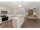 Open concept kitchen and living room with fireplace and hardwood floors at 1121 Talisker Way, Burlington, NC 27215