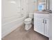 Simple bathroom with a shower/tub combo, white vanity, and tile floor at 10210 Sablewood Dr # 101, Raleigh, NC 27617