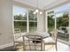 Bright breakfast nook with table and chairs, and view to backyard at 3455 Piedmont Dr, Raleigh, NC 27604