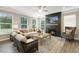 Spacious living room with a modern fireplace and large windows at 3455 Piedmont Dr, Raleigh, NC 27604