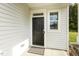 Modern dark-stained front door with sidelight window at 3455 Piedmont Dr, Raleigh, NC 27604
