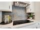 Modern kitchen features a sleek induction cooktop and a hexagon tile backsplash at 3455 Piedmont Dr, Raleigh, NC 27604