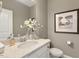 Stylish powder room with white vanity and granite countertop at 3455 Piedmont Dr, Raleigh, NC 27604