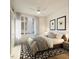 Spacious bedroom with large windows, neutral decor, and a ceiling fan at 106 Broadway St # 101, Durham, NC 27701