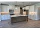 Modern kitchen with white cabinets, island, and pendant lighting at 104 Mossy Falls Way, Wendell, NC 27591