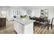 Open concept kitchen with island and dining area at 6698 Gibraltar Rock Dr, Raleigh, NC 27610