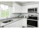 White kitchen cabinets and granite countertops at 6698 Gibraltar Rock Dr, Raleigh, NC 27610