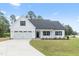 White farmhouse style home with landscaping at 204 Rocking Canal Pl, Erwin, NC 28339