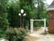 Landscaped garden with a path, arbor, and charming garden accents at 236 Olde Ferry Ln, Dunn, NC 28334