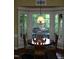 Bright breakfast nook with a round table and bay window at 236 Olde Ferry Ln, Dunn, NC 28334